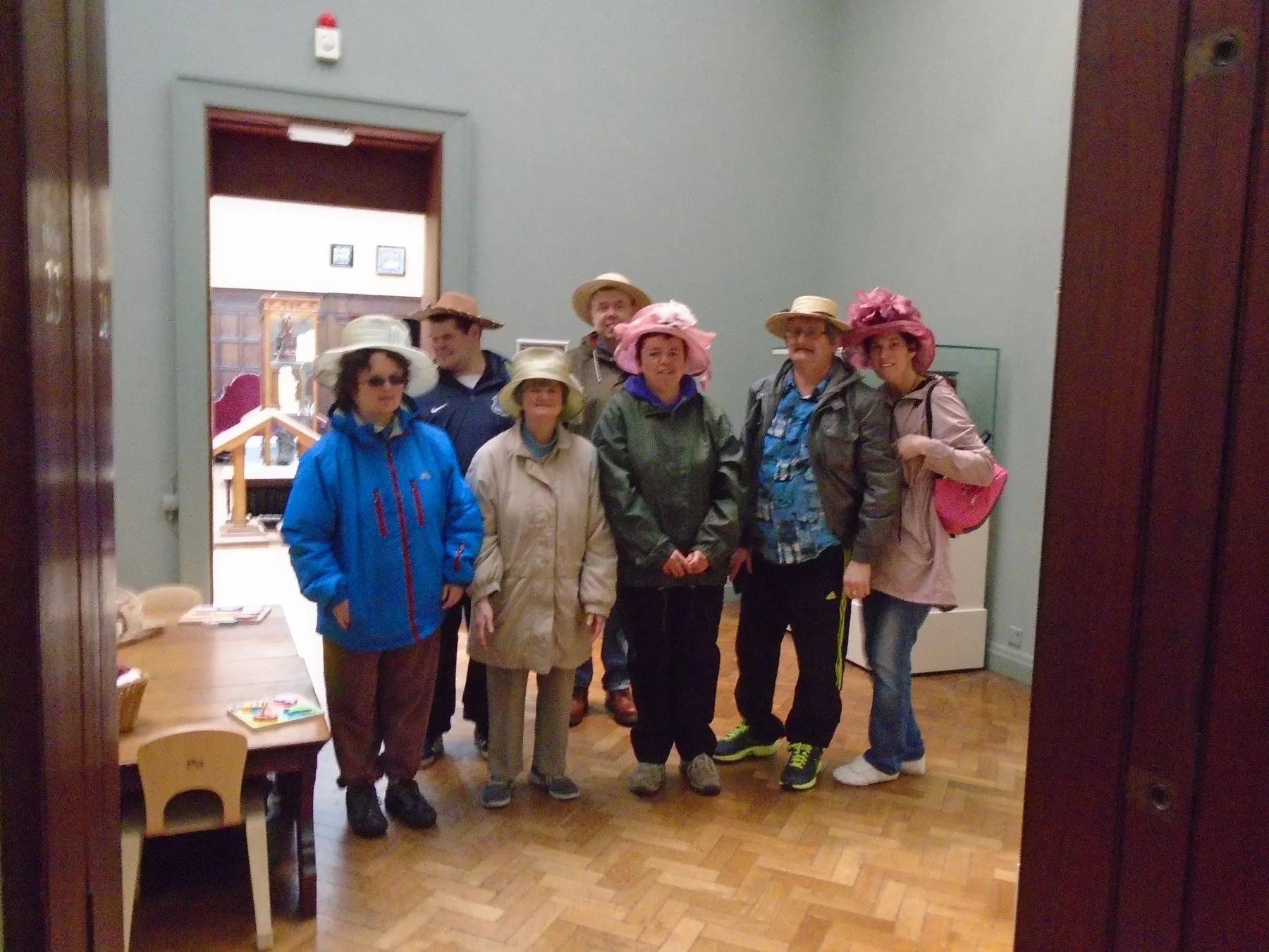 A group of members in colourful hats at the centre