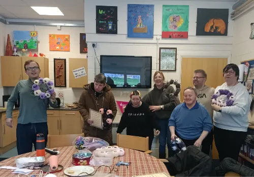 Members and support workers together in the activity room