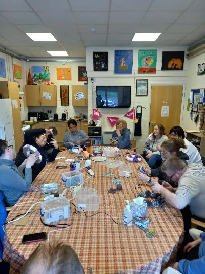 A table of members busy with arts and crafts